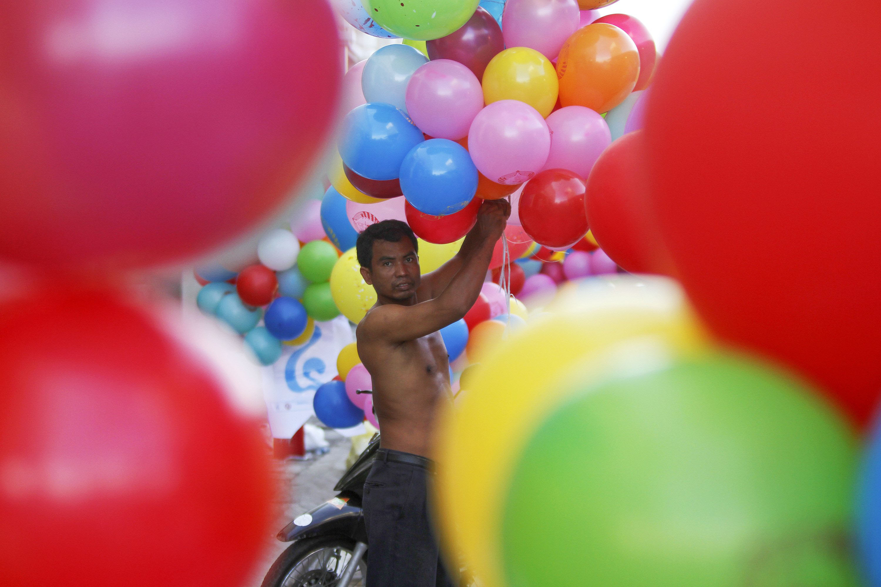 Un simpatizante del Partido Popular de Camboya prepara los globos para celebrar la probable reelecci