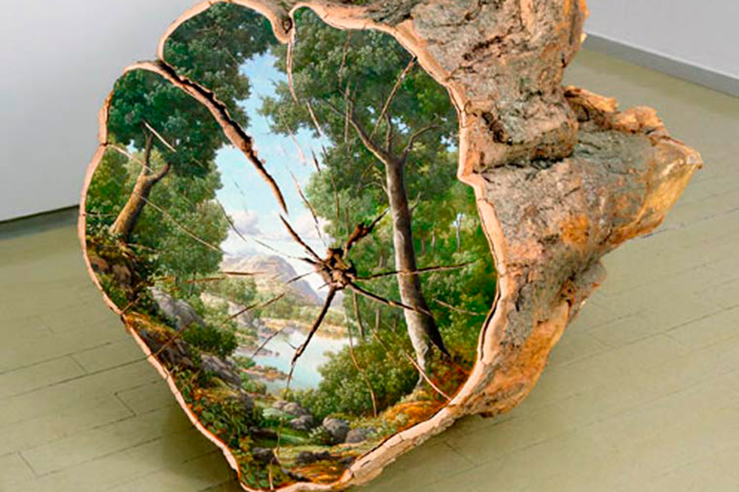 Artist paints the natural origins of trees on fallen logs.