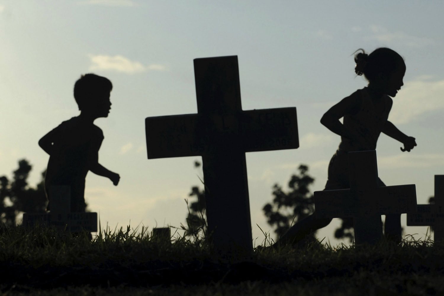 Families around the world honor their dead during the All Saints’ Day