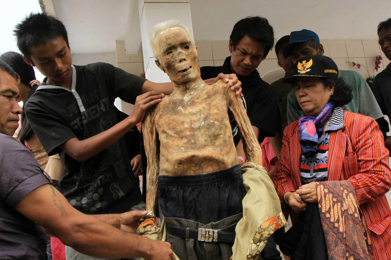 Indonesia digs up their dead, dresses and parades them in the streets