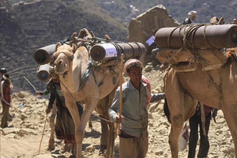 Contrabandistas transportando cilindros de oxígeno a través de las montañas  (RRSS/Taha Saleh)