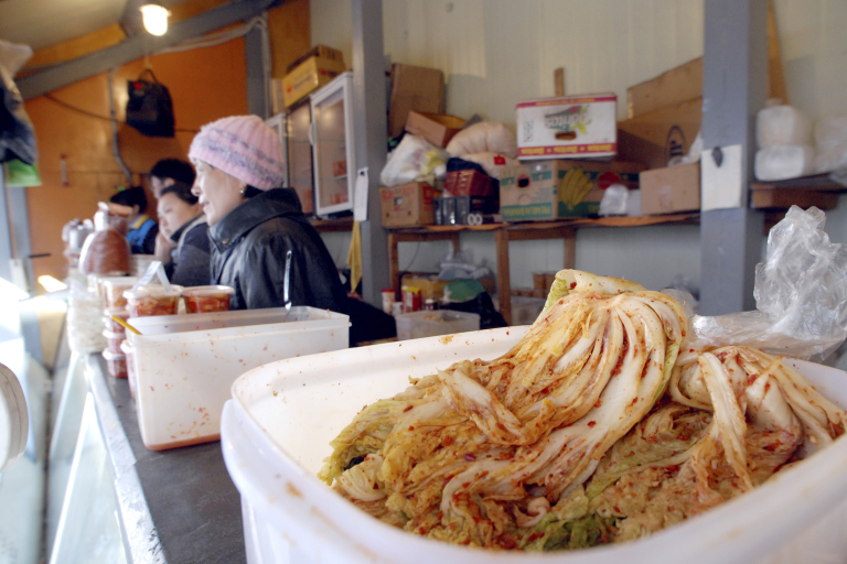 Ethnic Koreans sell kimchi, Korean pickled cabbage, at a market in Yuzhno-Sakhalinsk, Russia on Wednesday, Oct. 24, 2007.  (AP Photo/Burt Herman)
