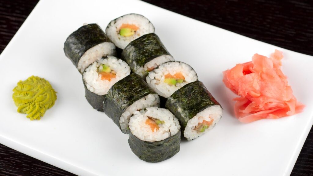 Varias piezas de sushi de salmón y aguacate.