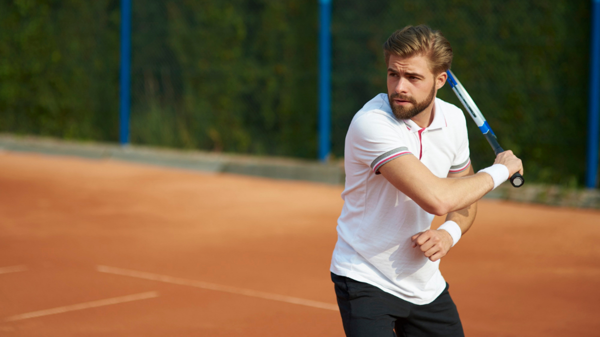 Un hombre joven jugando al tenis