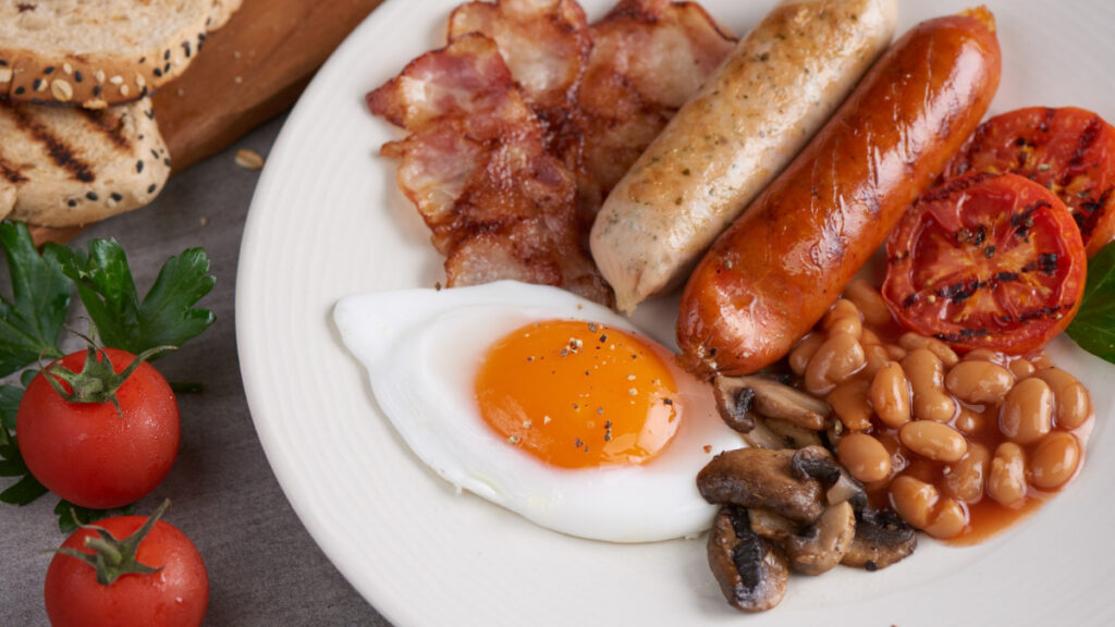 Un ejemplo clásico del english breakfast con salchichas, huevo, beicon y champiñones