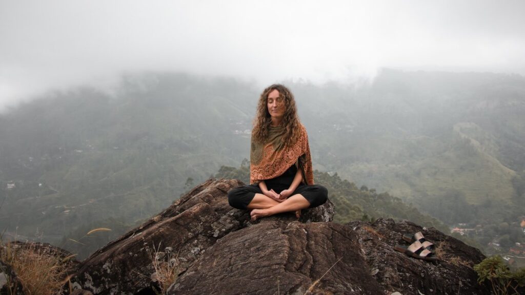 Una mujer meditando en la naturaleza. 