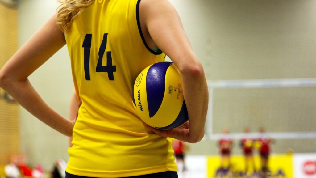 Una deportista con un balón voleibol. 
