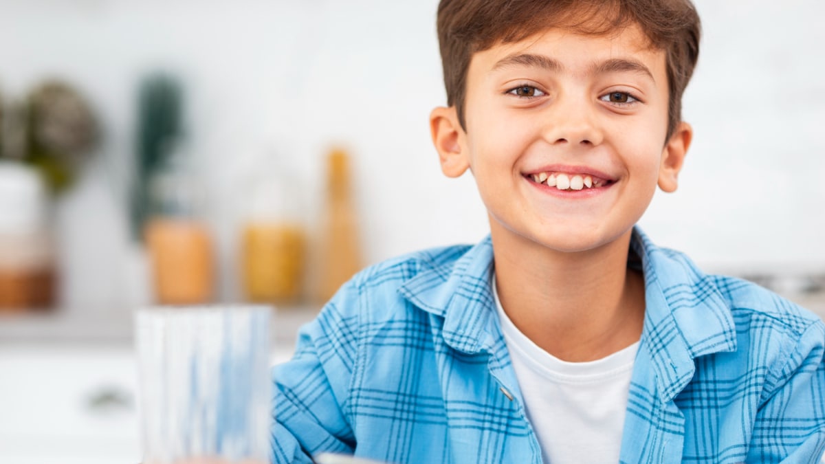 Un niño delante a punto de desayunar.