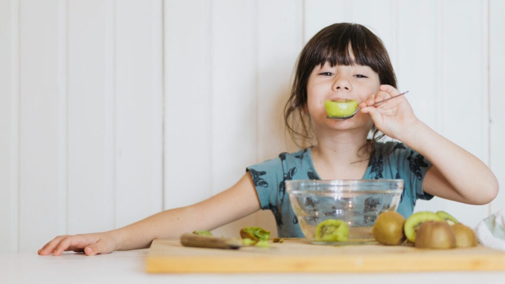 Una niña come una merienda saludable