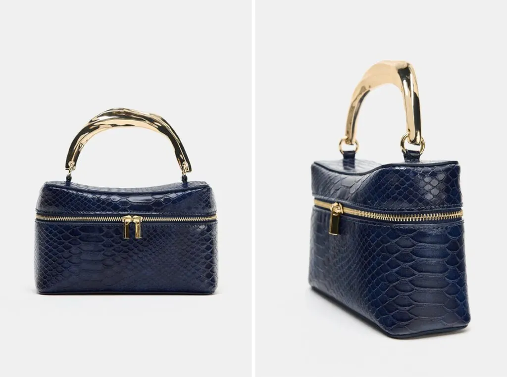 Bolso negro con asa dorada y rígida de Zara. (PVP: 29.95€)